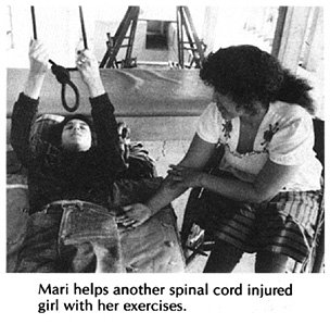 Mari helps another spinal cord injured girl with her exercises.