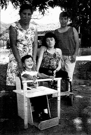 Children with their wheelchair and special seat.