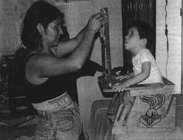 A child is playing with toys hanging from the bar.(photo 3)