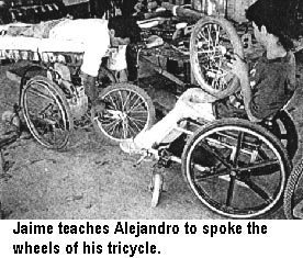 Jaime teaches Alejandro to spoke the wheels of his tricycle.
