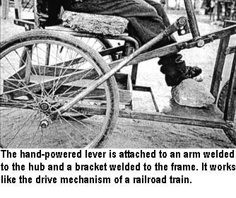 The hand-powered lever is attached to an arm welded to the hub and a bracket welded to the frame. It works like the drive mechanism of a railroad train.