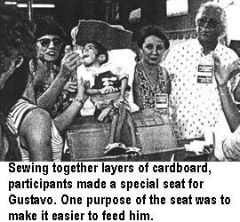 Sewing together layers of cardboard, participants made a special seat for Gustavo. One purpose of the seat was to make it easier to feed him.