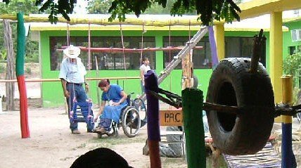 Marielos is painting the swing