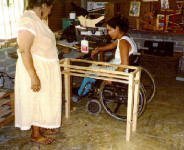 Marielos is making a table. Rosita is standing by.